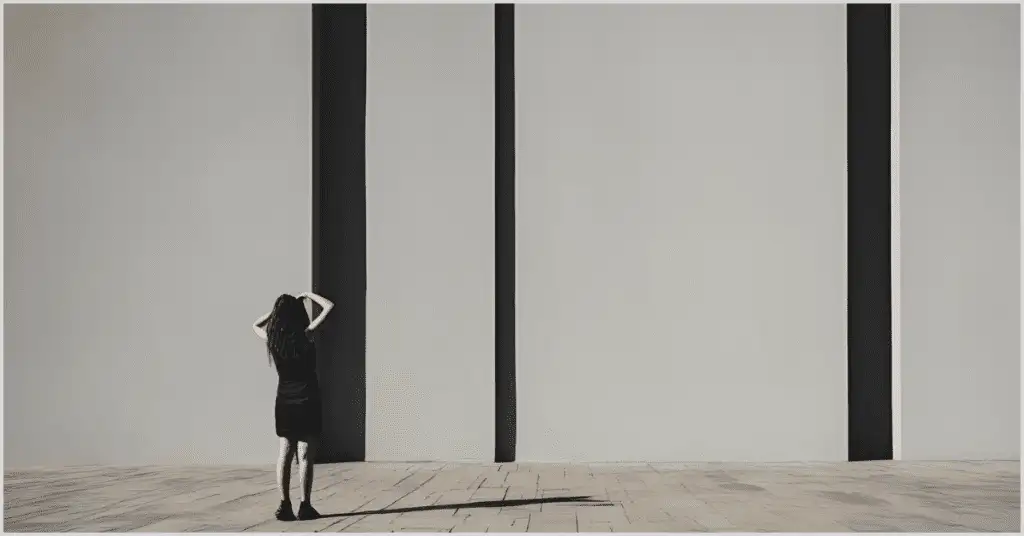 A girl looking at a wall with her shadow cast beside her, illustrating the impact of light and shadow in photography