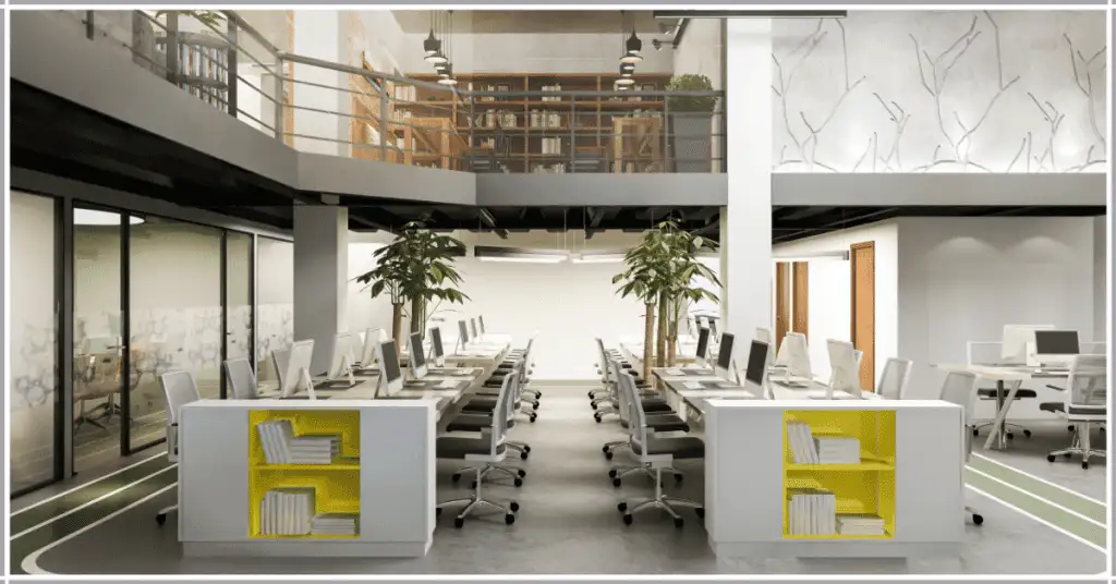 A modern office with workstations, yellow storage units, and plants under a mezzanine with bookshelves, showcasing office staging.