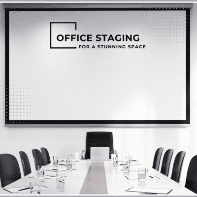 A modern conference room with a large screen displaying "Office Staging for a Stunning Space" logo, surrounded by black chairs and a long table with water glasses.