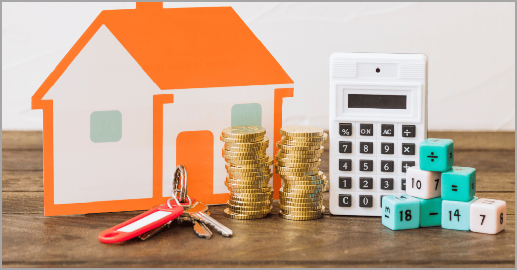 Model house, stacks of coins, calculator, keys, and math dice on a table representing financial planning for the Home Buying Timeline.