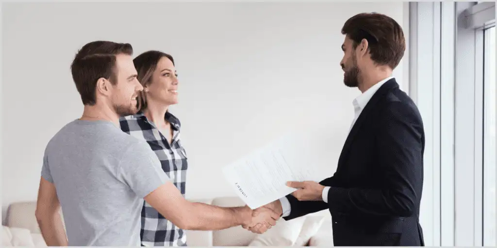 Real estate agent greeting visitors using open house scripts.
