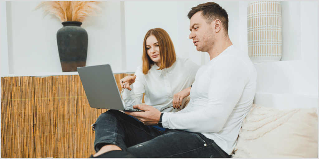 Couple reviewing open house call follow-up script on laptop.
