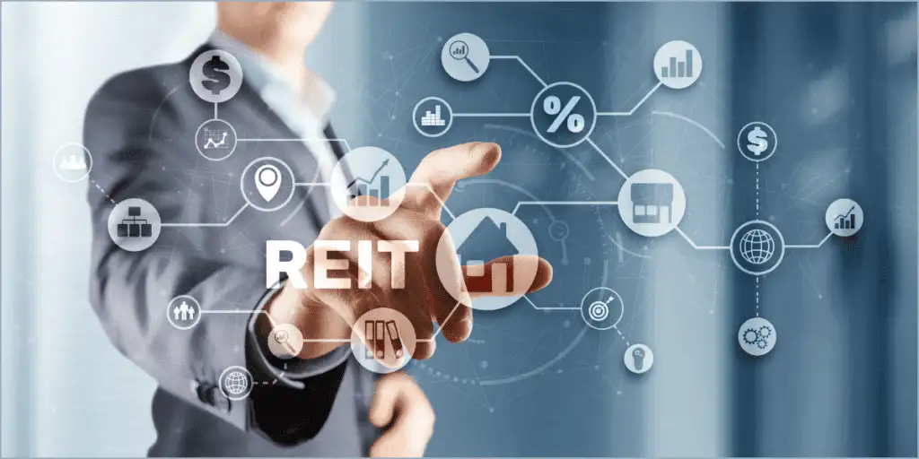 A person in a suit touching a holographic interface with "REIT" and icons like a house, graphs, and dollar signs, representing Real Estate Investing.