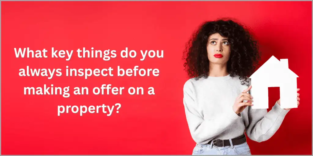 Woman holding a house cutout with text about property inspection.