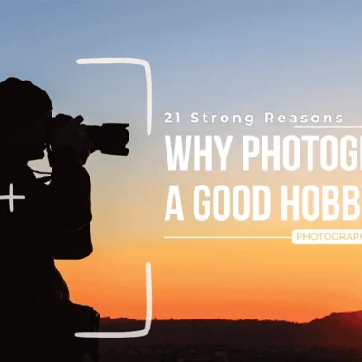 Silhouette of a photographer capturing a vibrant sunset landscape, framed with a camera viewfinder overlay and text reading "21 Strong Reasons Why Photography Is a Good Hobby."
