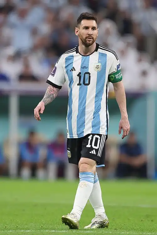 Lionel Messi in Argentina national team jersey number 10, walking on pitch with captain's armband – Who Is The Most Photographed Person In The World