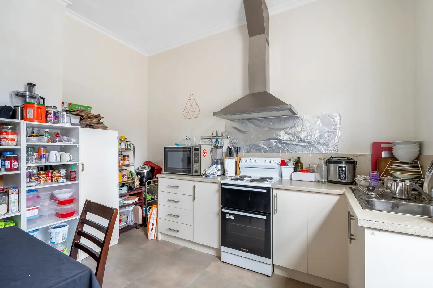 Cluttered kitchen before real estate object removal service by PixelShouters