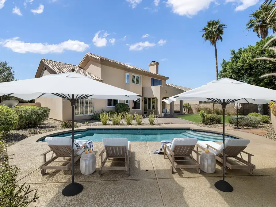 Pool patio after virtual outdoor staging with loungers and umbrellas