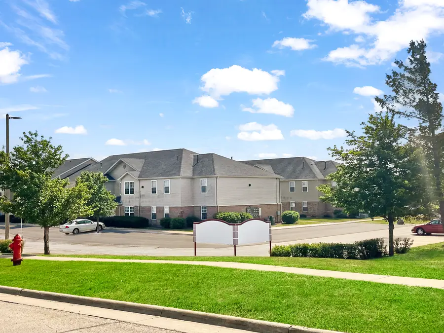 Real estate exterior after snow removal, green lawn replacement, and tree enhancement by PixelShouters