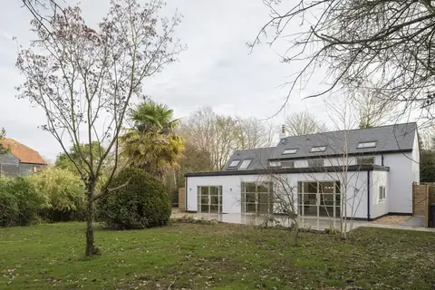Before exterior real estate photo editing with dull sky and lawn