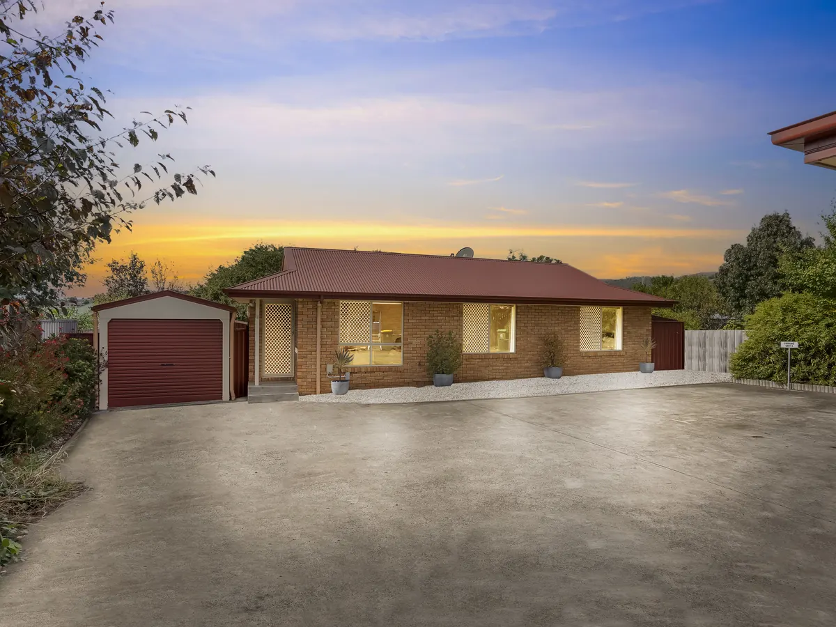 Real estate exterior after day-to-dusk editing with dusk sky and window glow by PixelShouters