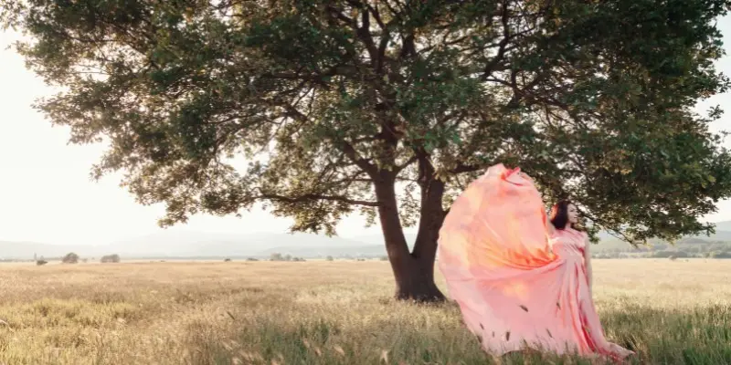 Woman in peach gown under tree showing Vintage and Retro Different Photo Editing Styles