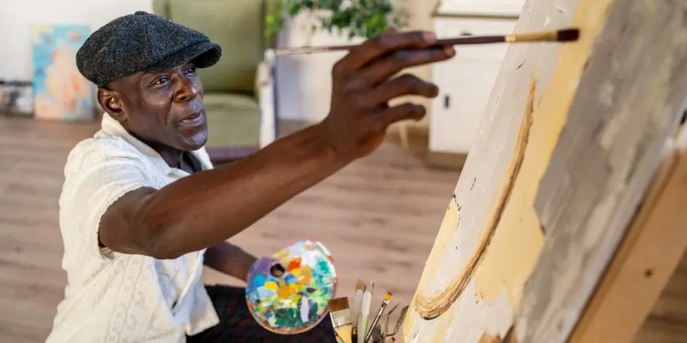 Artist painting a realistic canvas in studio, showing difference between Realism in Photography and art photorealism